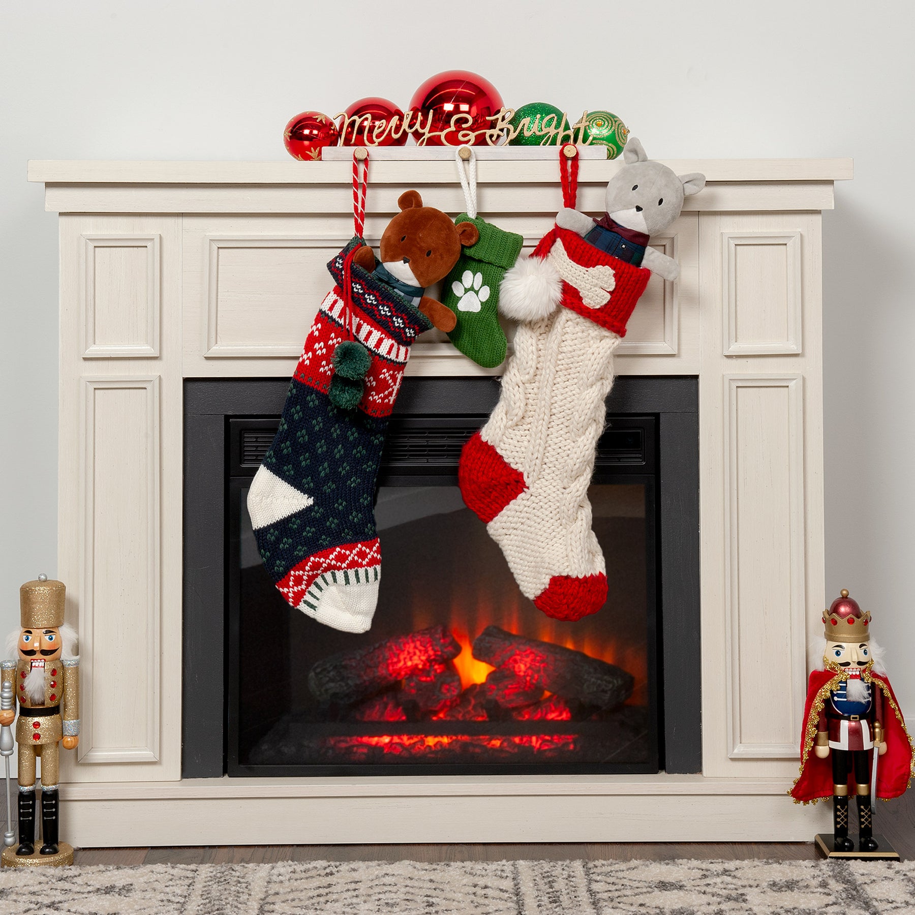 Two Stockings with stuffed animals in them hanging on a mantlepiece during the holiday season at FurHaven Pet Products